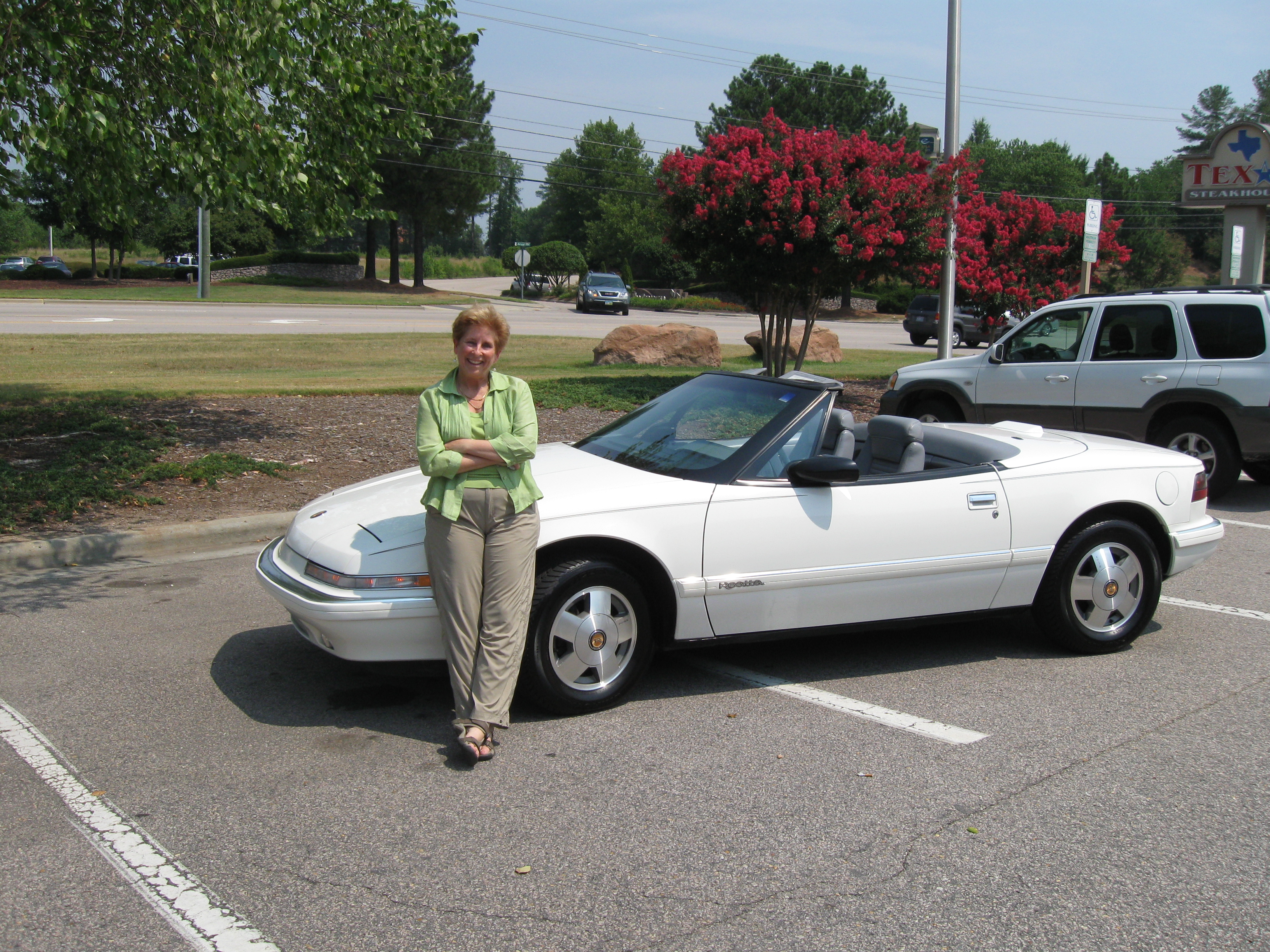 Robin W. of Atlanta, GA and her 1990 convertible she bought from us